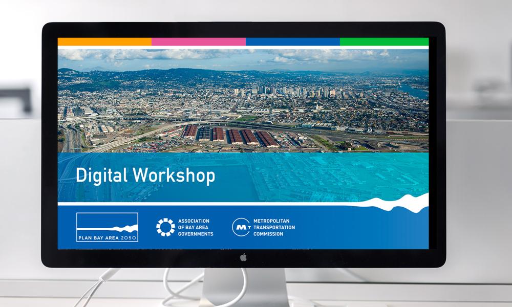 A desktop computer monitor displays a Powerpoint presentation with "Digital Workshop" showing.